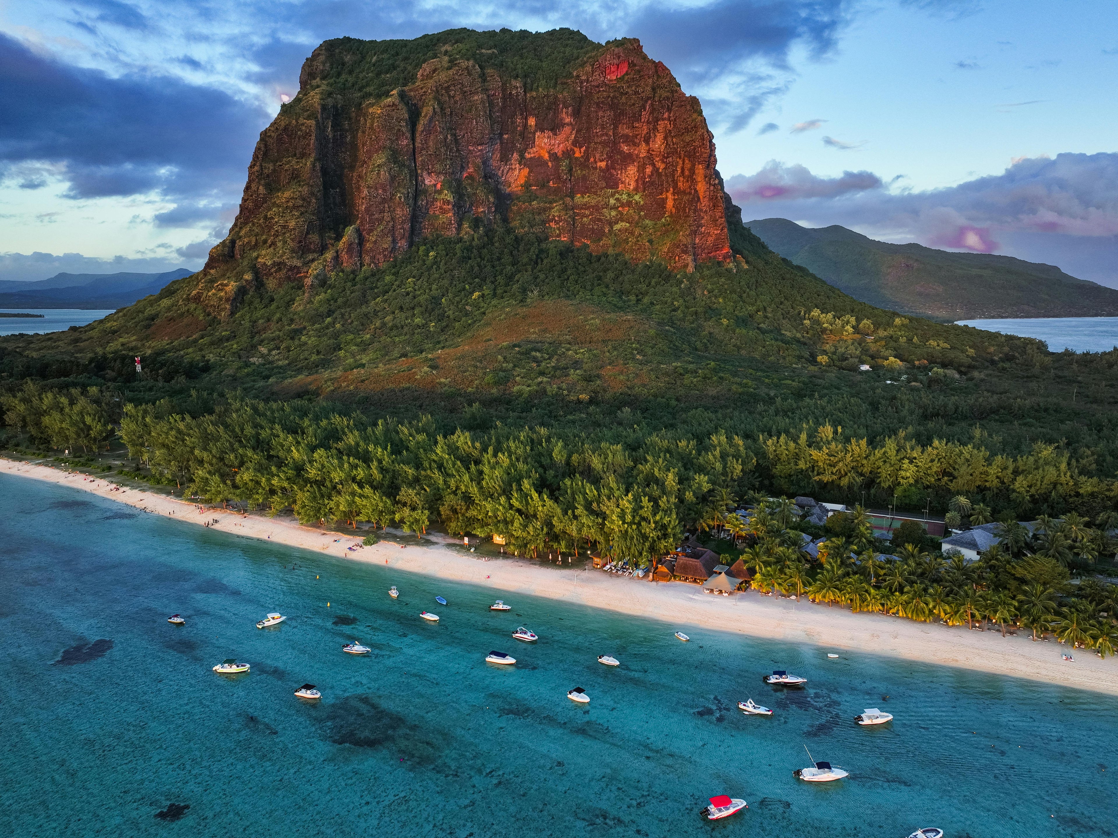 Beach with boats and a large mountain in the background - Le Morne Brabant Mauritius